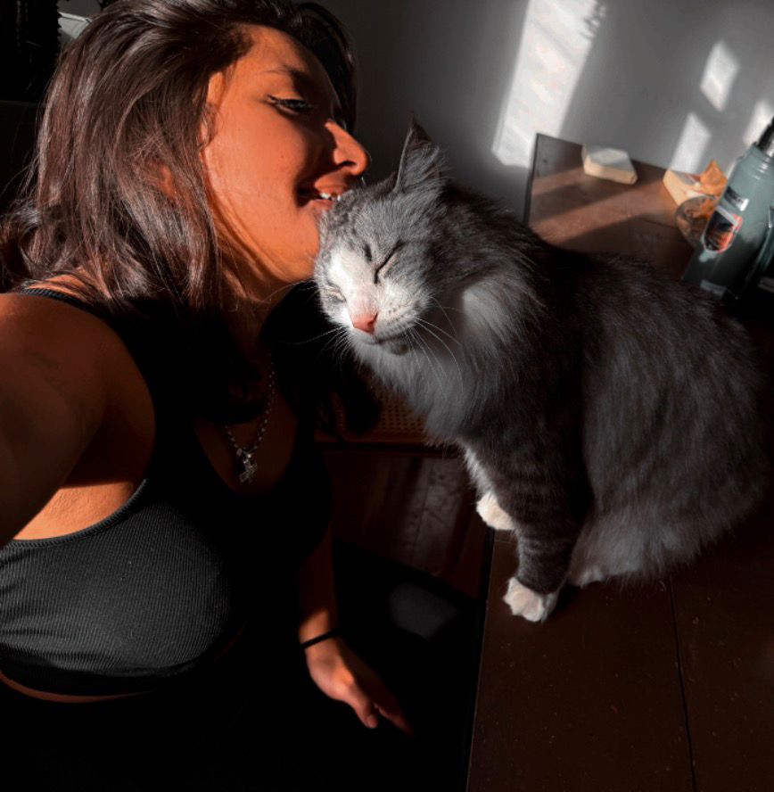 Selfie of Sofia with a grey cat in warm sunlight