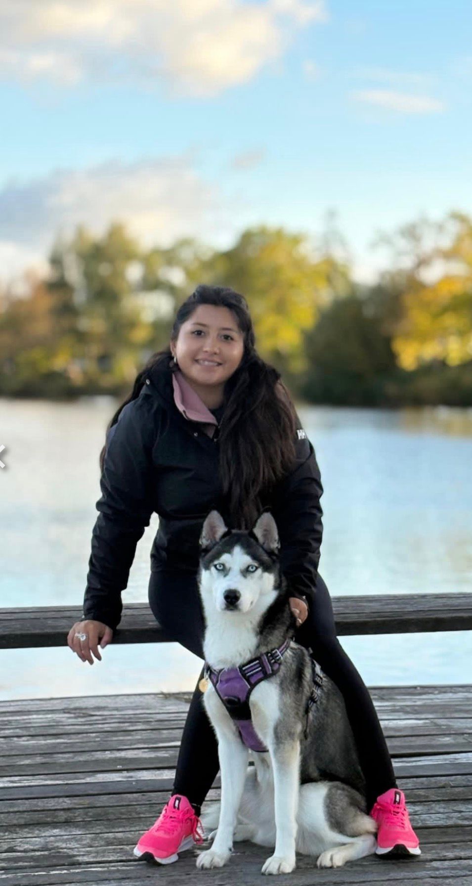 Sofia with a husky on a dock by the lake